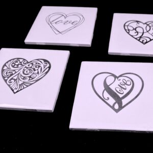 Image of engraved white coasters with decorative heart design - Donley Woodworking