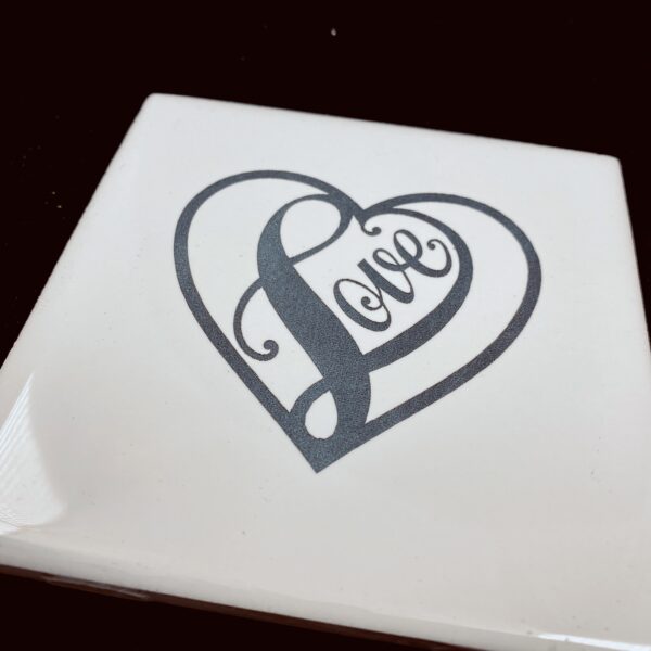 Image of engraved white coasters with decorative heart design - Donley Woodworking