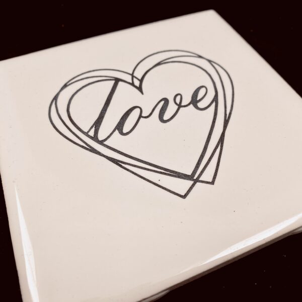 Image of engraved white coasters with decorative heart design - Donley Woodworking